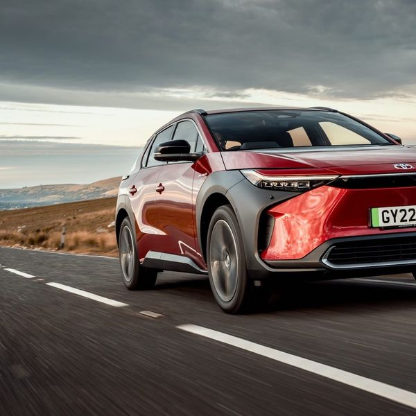 Toyota bZ4x tracking action shot, red car, UK registration